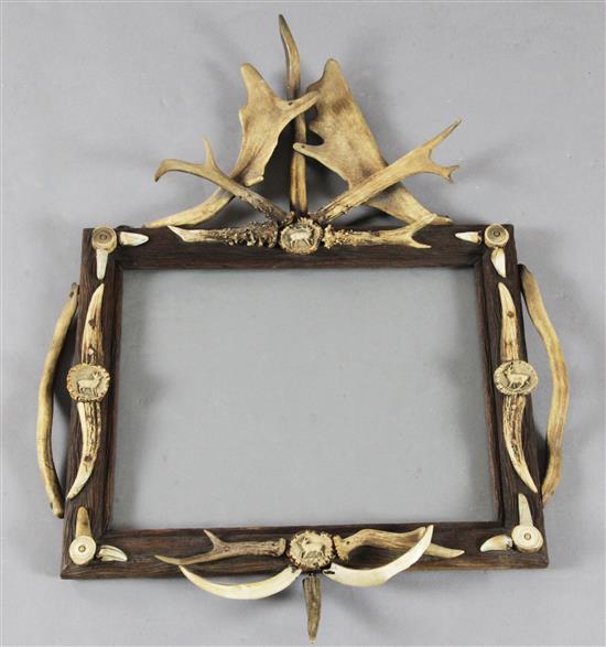 A Black Forest stag horn and antler mounted picture frame, height 29in. width 22in.